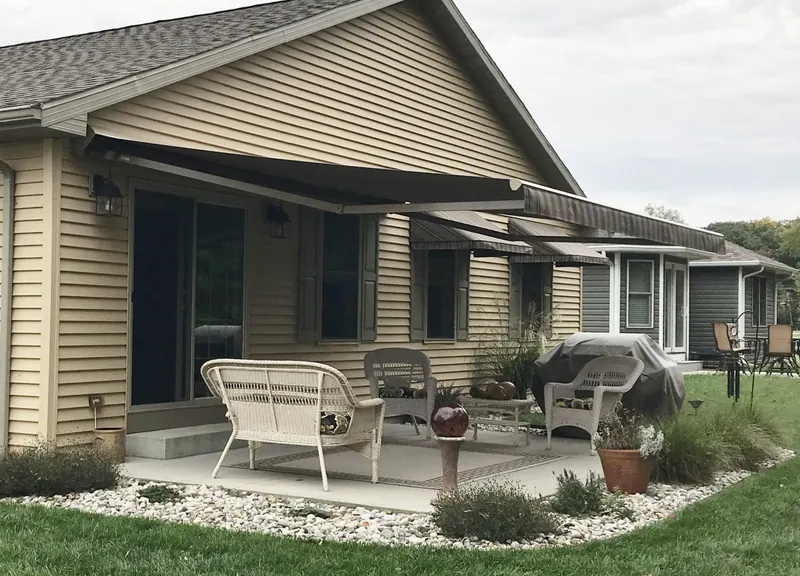 Sunesta retractable patio cover extended over a home patio in a neutral solution-dyed acrylic fabric